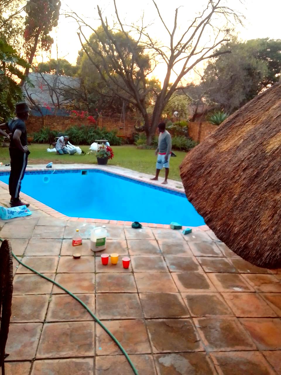 Team beside finished pool at dusk